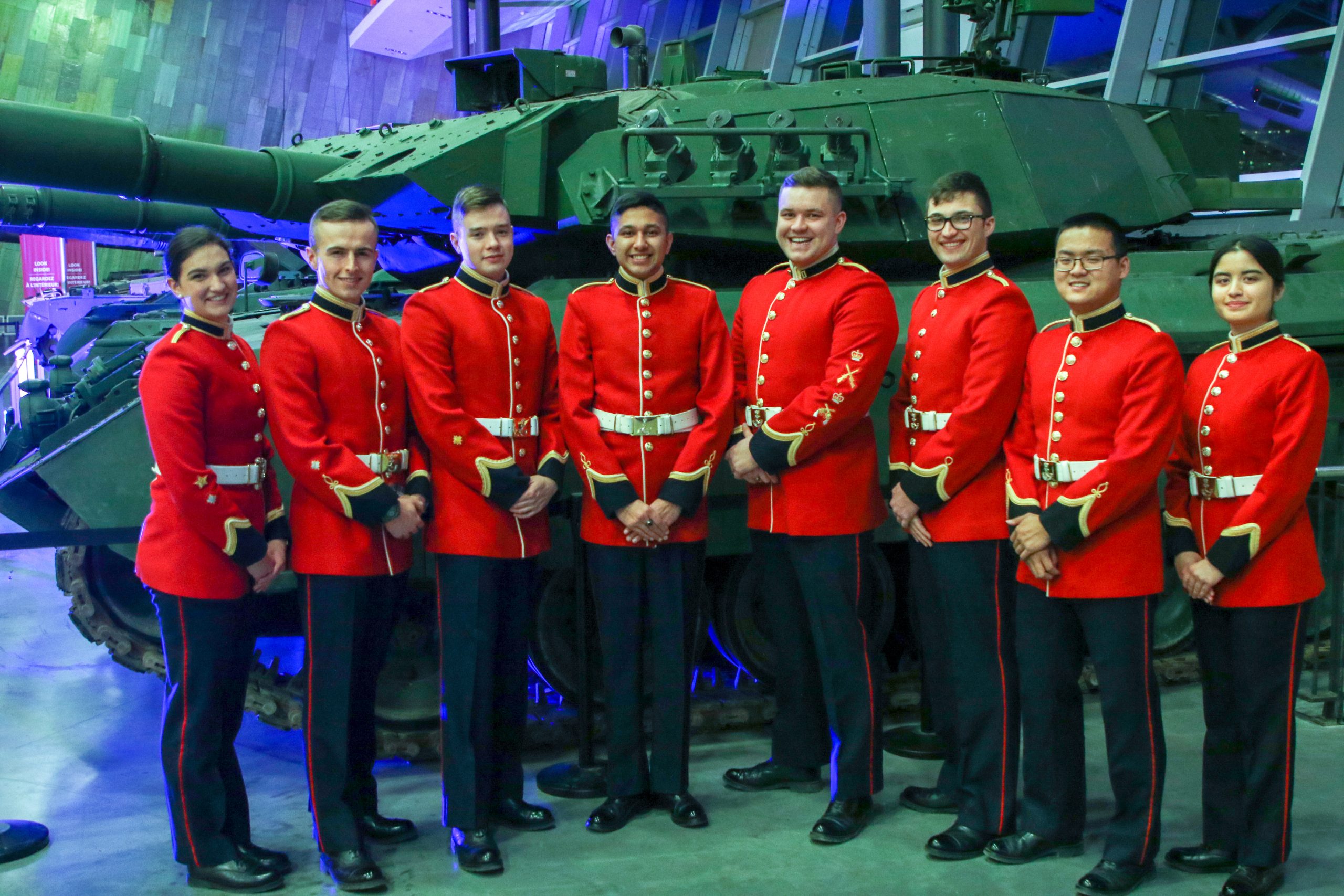 RMC Debate and International Affairs Society in front of tank display
