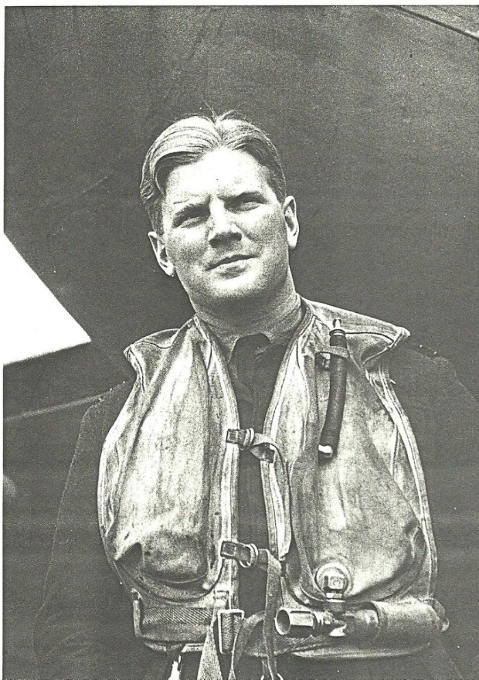 A man in a military uniform wearing an inflatable life jacket.